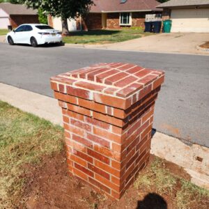 Wide view of leaning brick mailbox repair example during leveling work